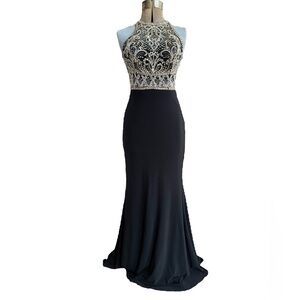 Clarisse fitted evening dress with halter neckline heavily beaded small train.